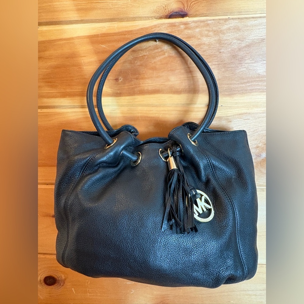 Michael Kors Ring Purse with Tassel and logo.